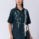 A vibrant green cotton shirt, adorned with stunning bead and hand embroidery. With a classic collar and half sleeves, it's perfect for a sophisticated yet comfortable Western look.
