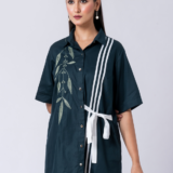 A vibrant green cotton shirt, adorned with stunning bead and hand embroidery. With a classic collar and half sleeves, it's perfect for a sophisticated yet comfortable Western look.