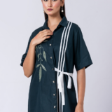 A vibrant green cotton shirt, adorned with stunning bead and hand embroidery. With a classic collar and half sleeves, it's perfect for a sophisticated yet comfortable Western look.