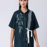 A vibrant green cotton shirt, adorned with stunning bead and hand embroidery. With a classic collar and half sleeves, it's perfect for a sophisticated yet comfortable Western look.