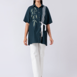 A vibrant green cotton shirt, adorned with stunning bead and hand embroidery. With a classic collar and half sleeves, it's perfect for a sophisticated yet comfortable Western look.